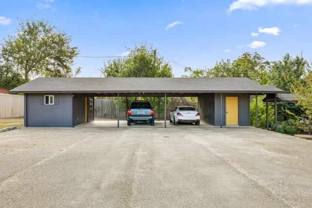 a view of a house with a yard and garage
