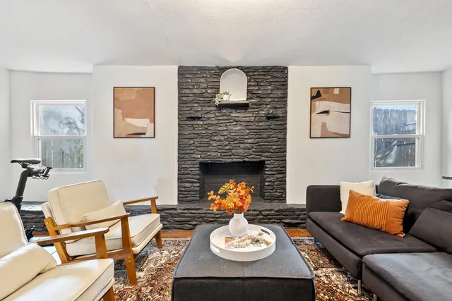 a living room with furniture and a fireplace