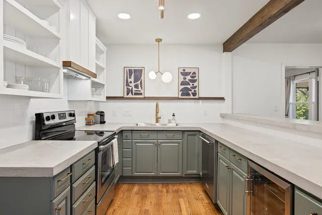 a kitchen with a sink stove and cabinets