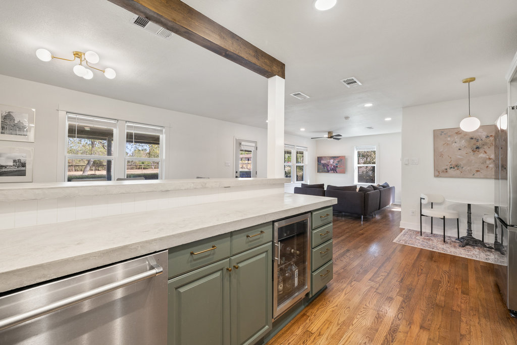 7511 Old Bee Cave Road, Unit 2 Austin, TX 78735 - Photo 7 of 39 a spacious kitchen with stainless steel appliances granite countertop a lot of counter space and a wooden floors