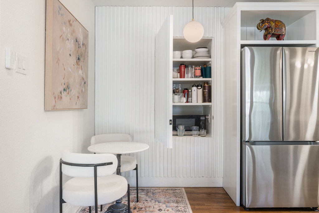 7511 Old Bee Cave Road, Unit 2 Austin, TX 78735 - Photo 8 of 39 a kitchen with stainless steel appliances granite countertop a refrigerator and a wooden floor