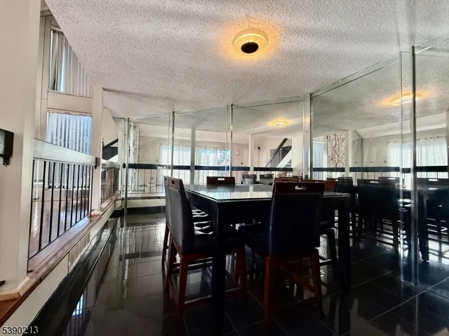 a kitchen with stainless steel appliances a dining table chairs and granite counter tops