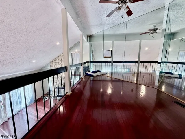 an empty room with wooden floor and closet area