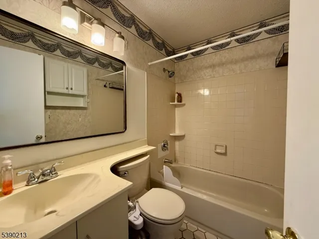 a bedroom with a bed and a rug