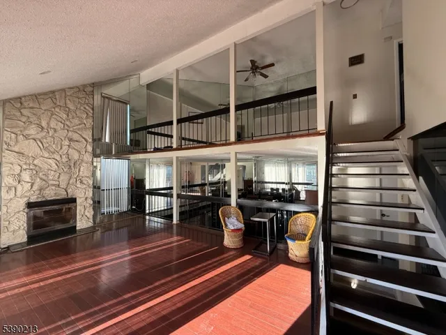 a view of a dining room with furniture a fireplace and chandelier