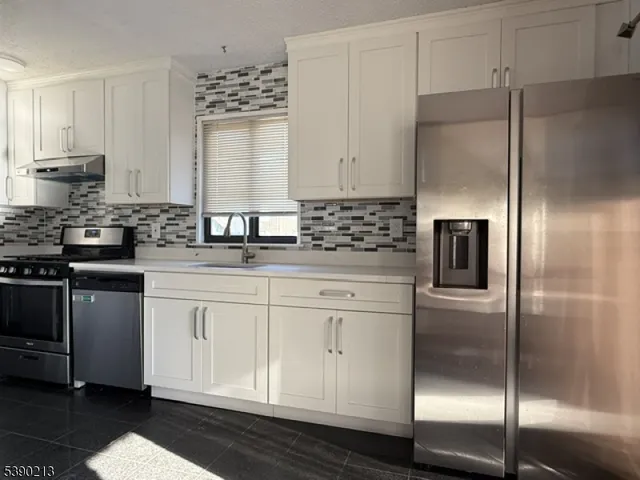 a kitchen with lots of counter top space and chairs