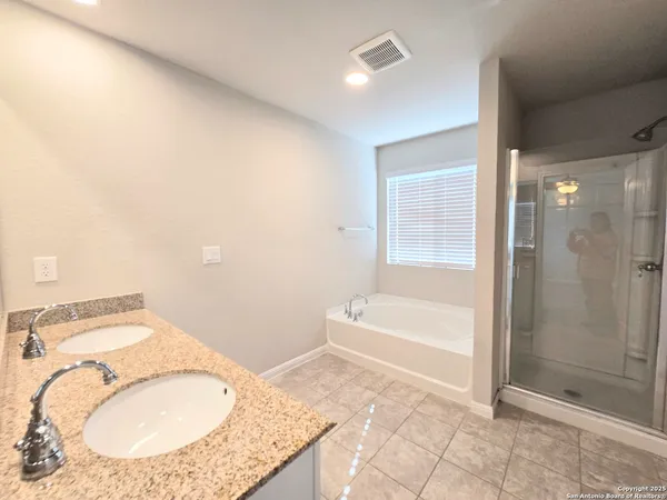 a bathroom with a granite countertop sink a toilet and shower