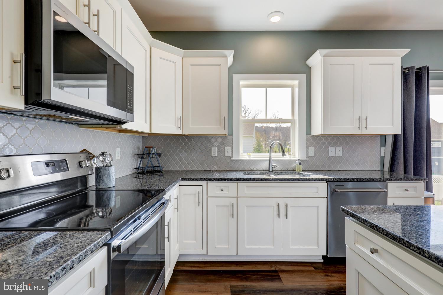 73 Summers Drive Stevens, PA 17578 - Photo 21 of 42 a kitchen with granite countertop white cabinets and stainless steel appliances