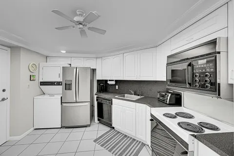 a kitchen with cabinets and steel appliances