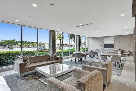 a living room with furniture and large windows