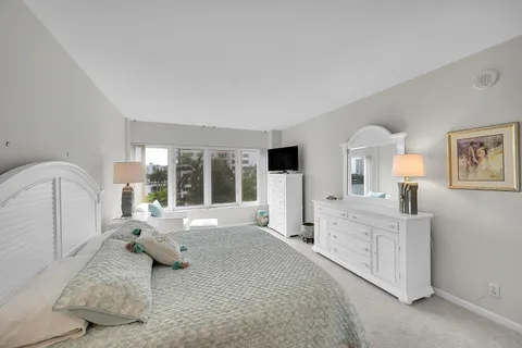 a bedroom with two beds and a large mirror