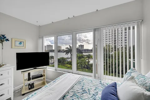 a view of a room with furniture and floor to ceiling window