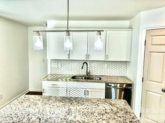 a kitchen with a stove a sink and a refrigerator