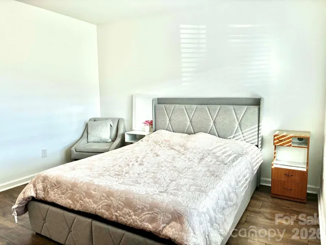 a bedroom with a bed and mirror