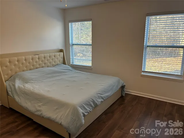 a large bed sitting in a bedroom next to a window