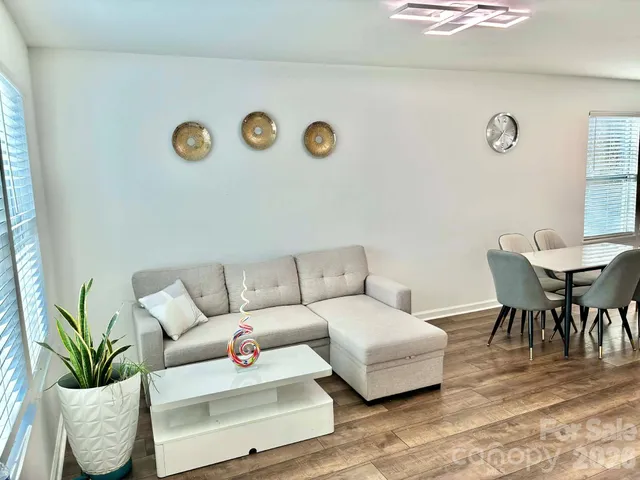 a living room with furniture and wooden floor