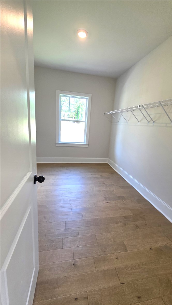 243 Holly Br Road Piedmont, SC 29673 - Photo 16 of 21 A well-lit closet space with wood flooring and convenient wire shelving.