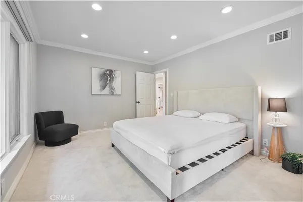 a large white bed in a white room