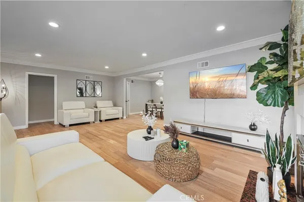 a living room with furniture and a chandelier
