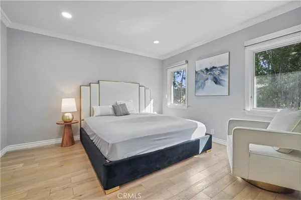 a bedroom with a large bed and a chandelier
