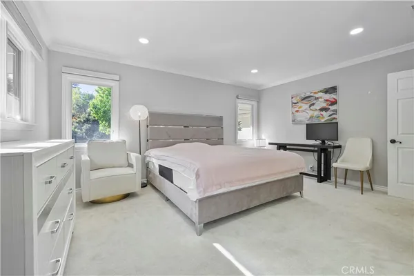 a bedroom with a large bed and a window