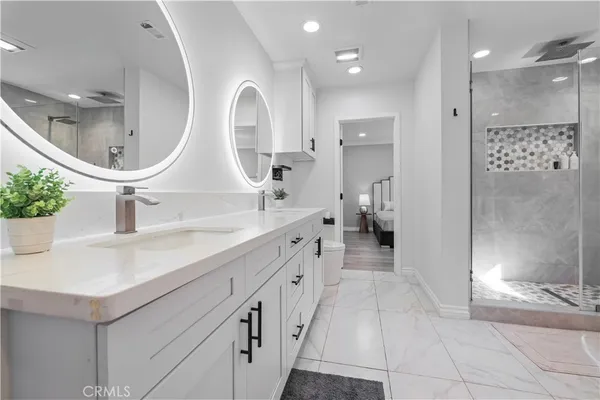 a bath tub sitting next to a white sink and vanity