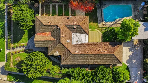an aerial view of a house with a yard and garden