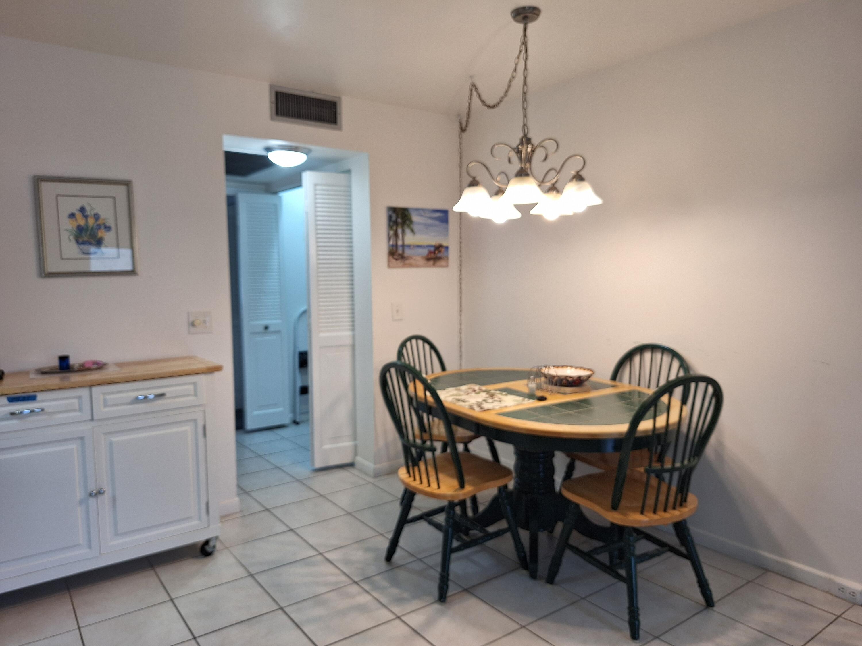 1010 Wolverton East Boca Raton, FL 33434 - Photo 3 of 30 a dining room with furniture and chandelier