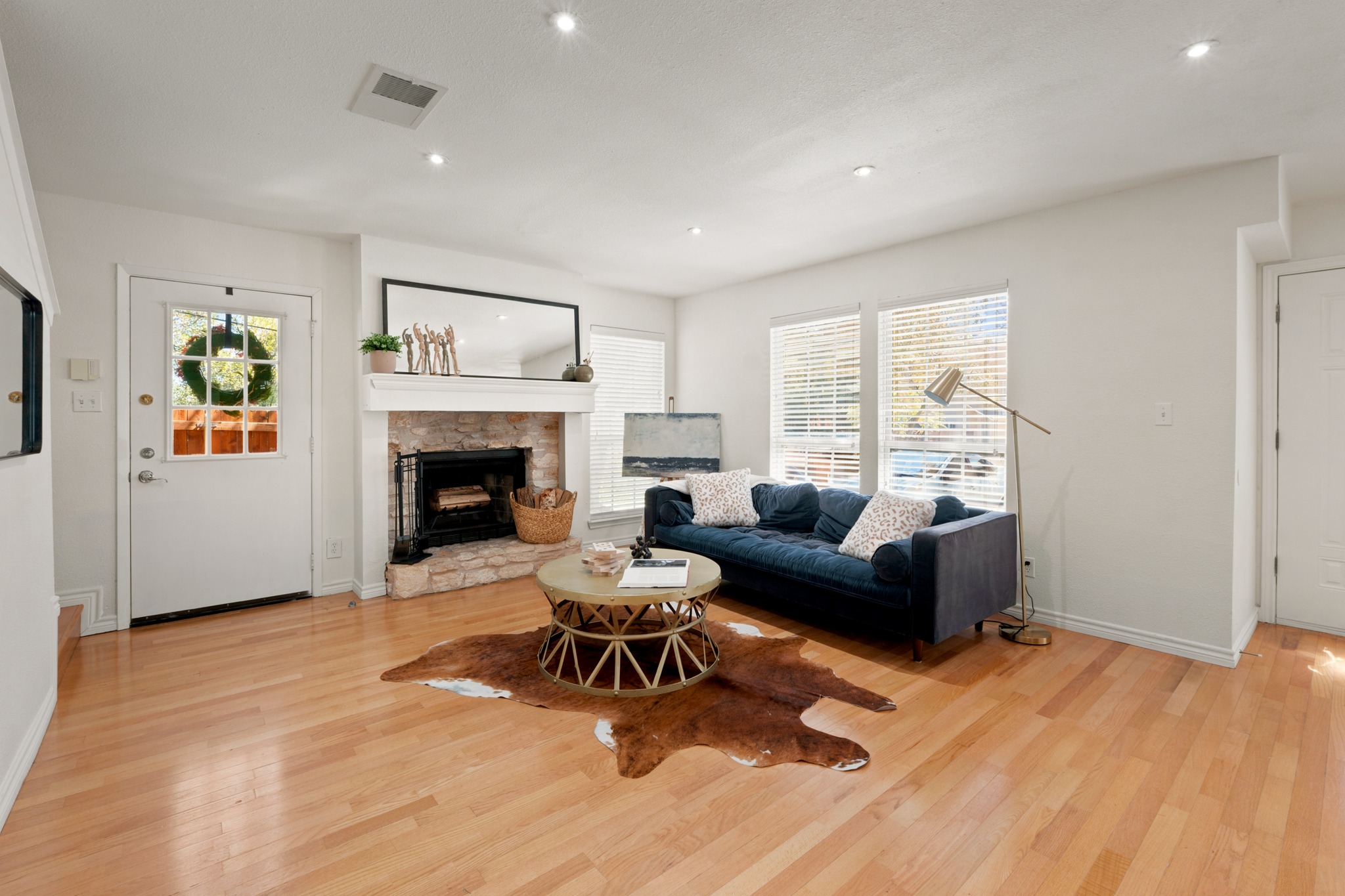 1504 Allen Road, Unit B Austin, TX 78746 - Photo 6 of 24 Gleaming hardwood floors and a classic stone fireplace anchor this welcoming living area.
