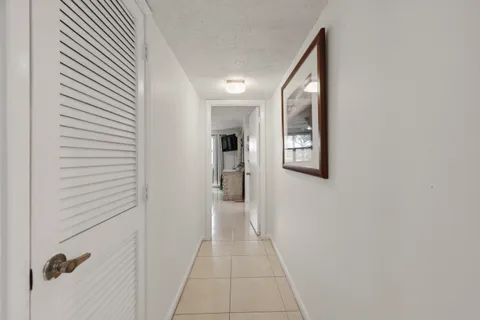a hallway with a dining table and a couch