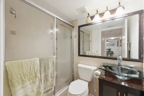 a view of a hallway with closet and bathroom