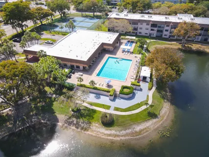 an aerial view of residential houses with outdoor space and river