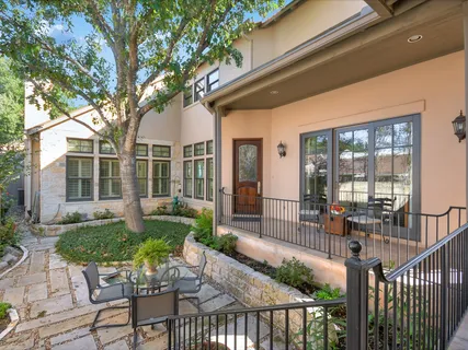 a view of a house with backyard and sitting area