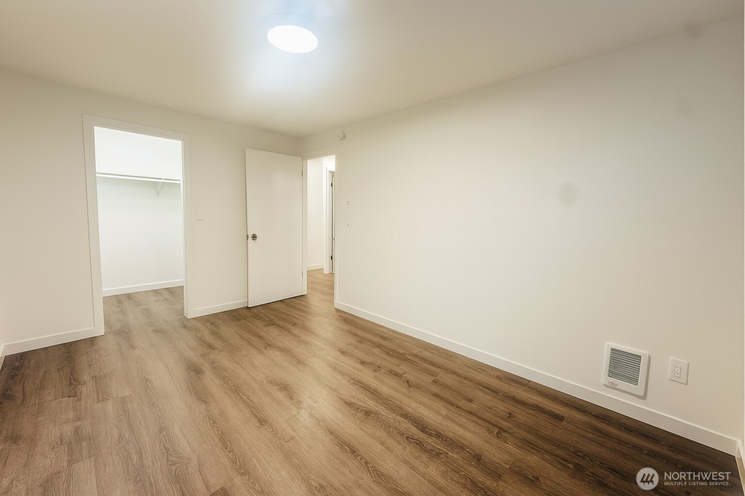 11211 Northeast 68th Street, Unit 3 Kirkland, WA 98033 - Photo 12 of 21 a view of an empty room with wooden floor