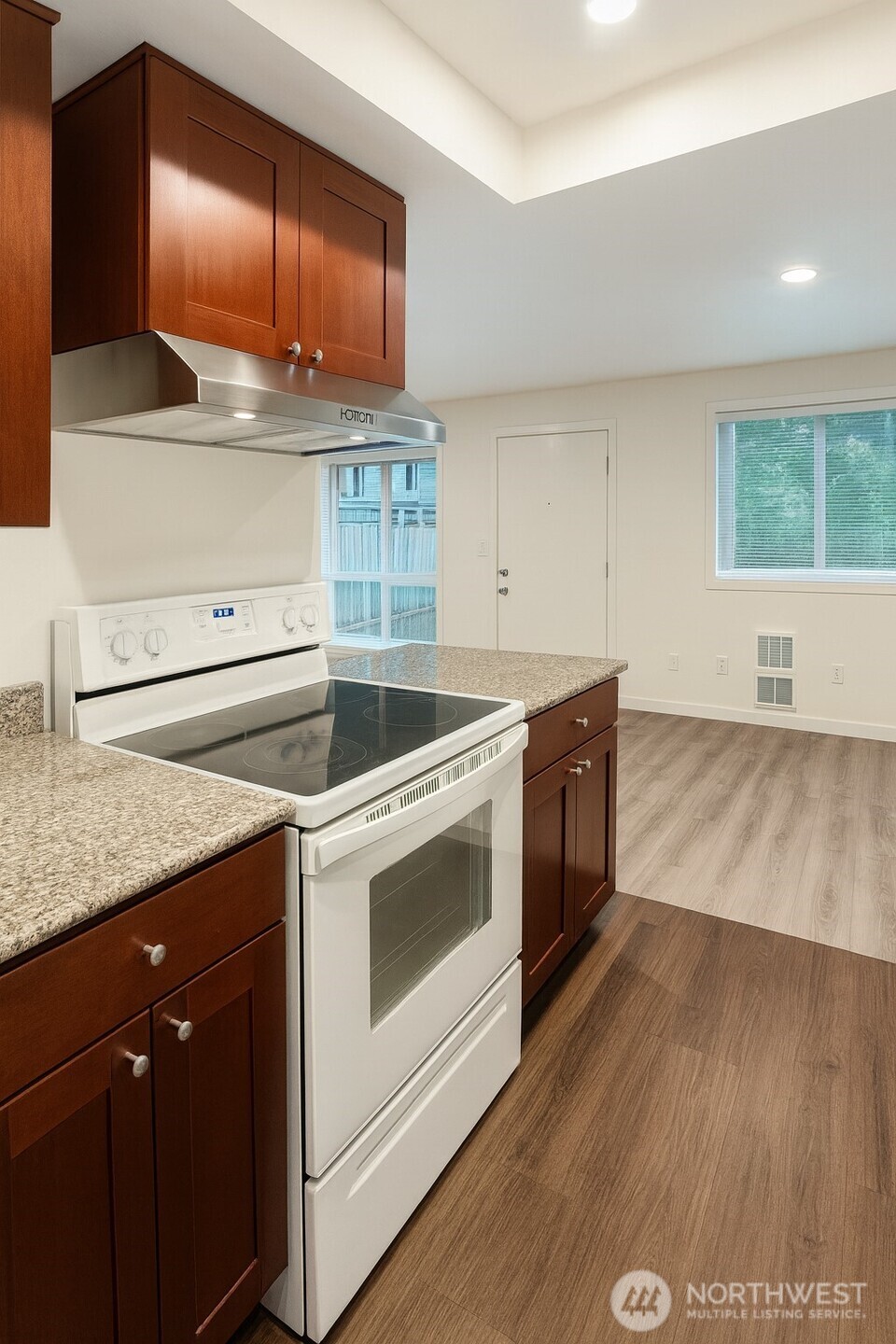 11211 Northeast 68th Street, Unit 3 Kirkland, WA 98033 - Photo 14 of 21 a kitchen with wooden floors and a sink