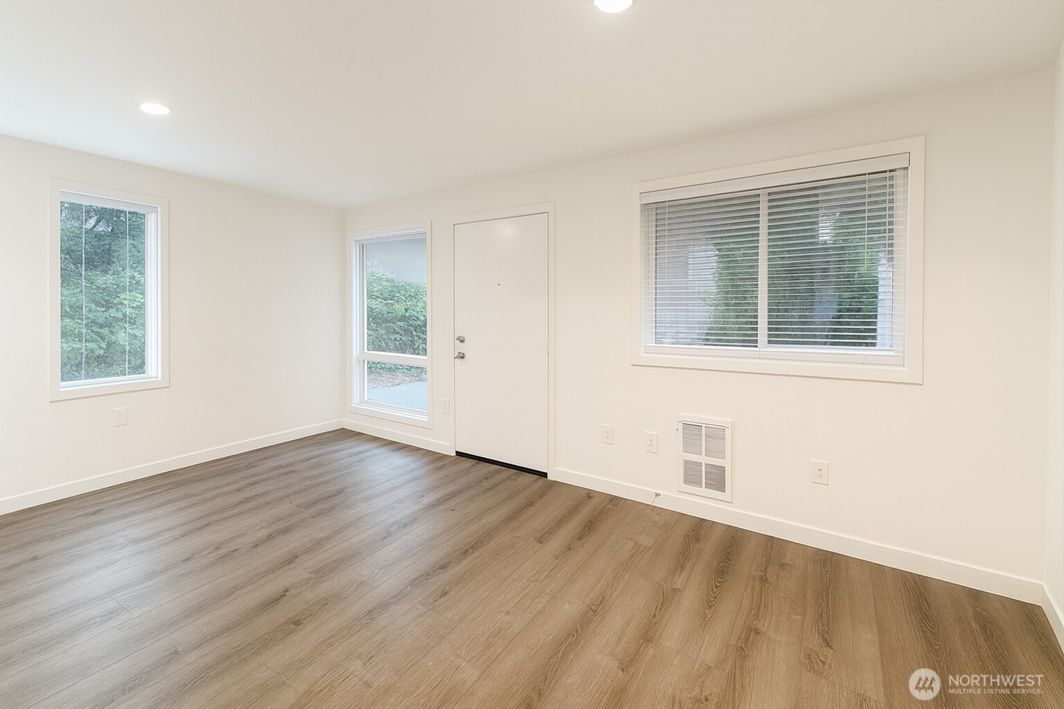 11211 Northeast 68th Street, Unit 3 Kirkland, WA 98033 - Photo 15 of 21 a view of an empty room with wooden floor and a window