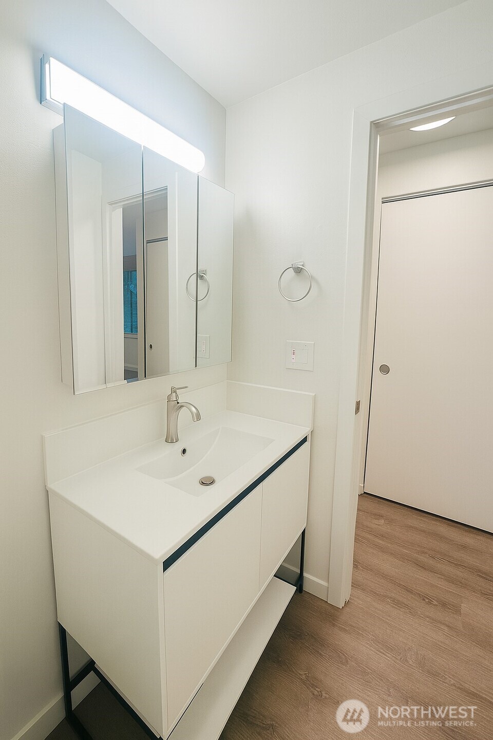 11211 Northeast 68th Street, Unit 3 Kirkland, WA 98033 - Photo 17 of 21 a bathroom with a sink a mirror and a shower