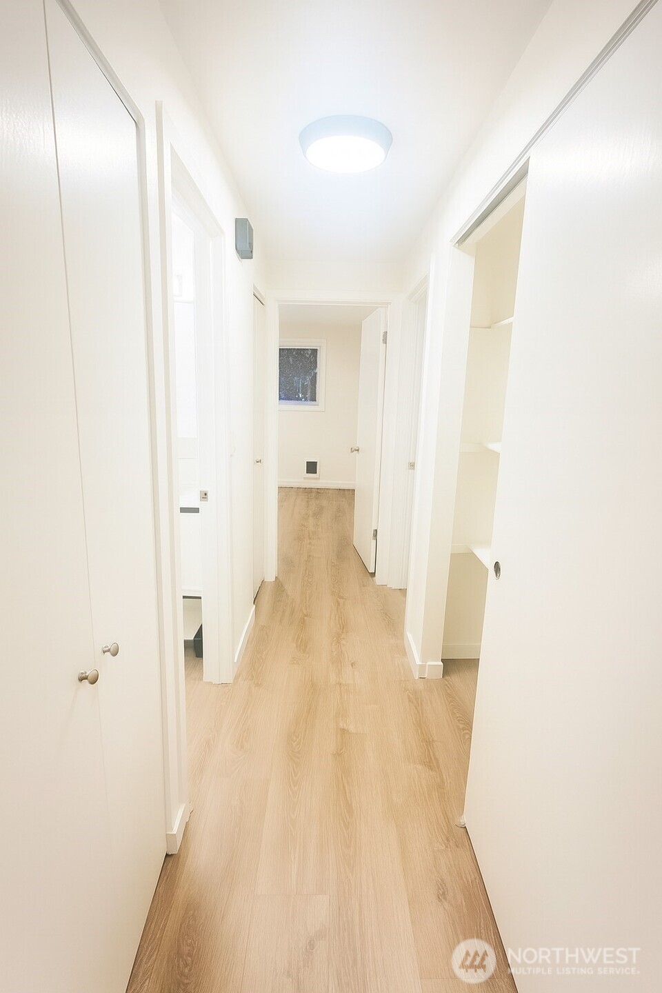 11211 Northeast 68th Street, Unit 3 Kirkland, WA 98033 - Photo 6 of 21 a view of a hallway with wooden floor
