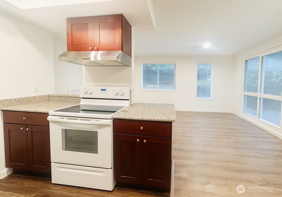 11211 Northeast 68th Street, Unit 3 Kirkland, WA 98033 - Photo 7 of 21 a kitchen with a stove and a sink