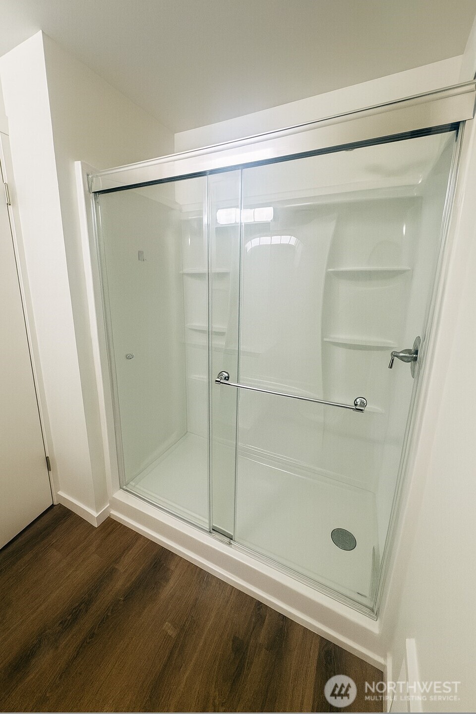 11211 Northeast 68th Street, Unit 3 Kirkland, WA 98033 - Photo 9 of 21 a bathroom with a glass shower door