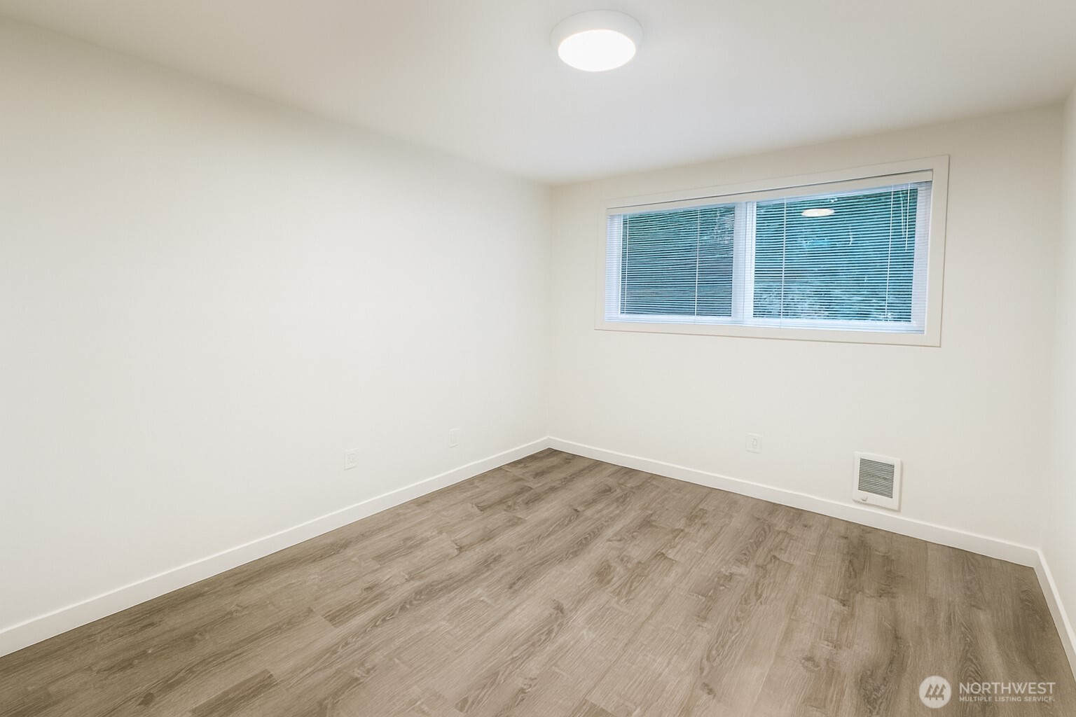 11211 Northeast 68th Street, Unit 3 Kirkland, WA 98033 - Photo 10 of 21 an empty room with a window