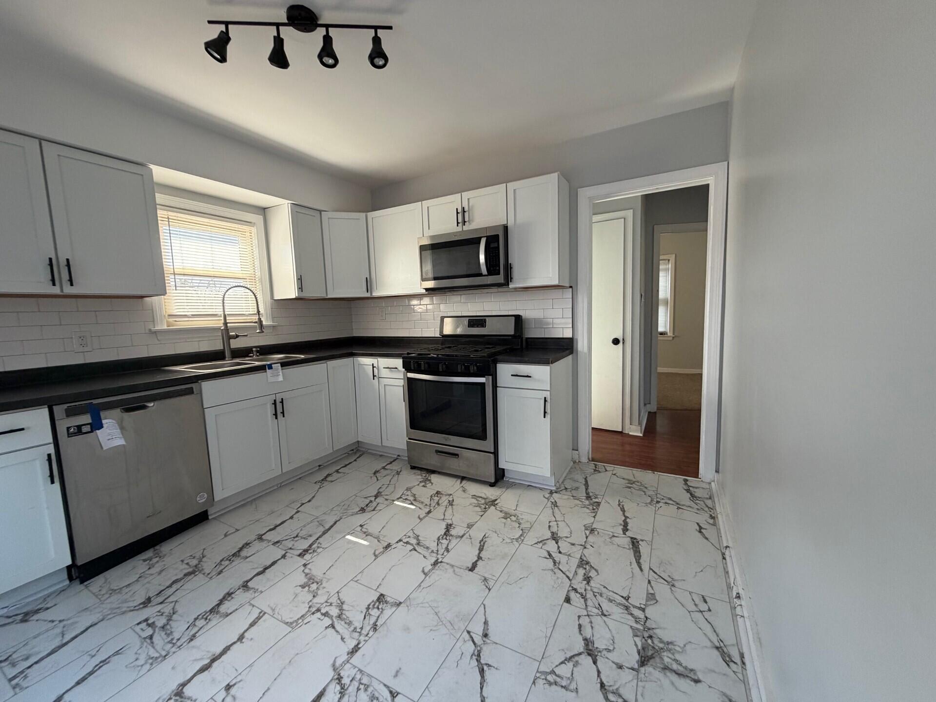 3134 Cleveland Street Hammond, IN 46323 - Photo 12 of 15 a kitchen with stainless steel appliances granite countertop a sink and cabinets