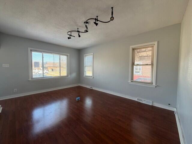3134 Cleveland Street Hammond, IN 46323 - Photo 3 of 15 a view of an empty room with wooden floor and a window