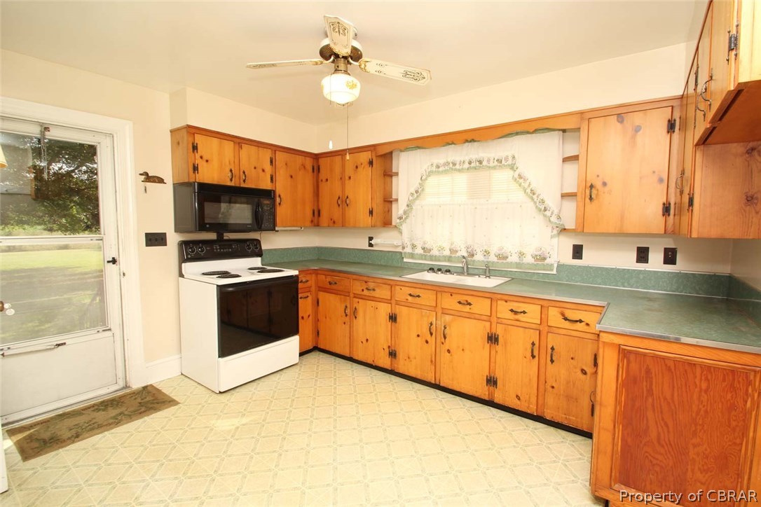 1818 Chownings Ferry Road Lancaster, VA 22503 - Photo 16 of 29 Charming country kitchen with pine cabinets, back door access