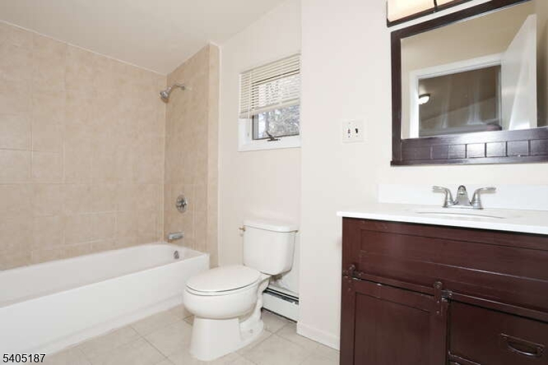 68 Mohawk Avenue Hawthorne, NJ 07506 - Photo 12 of 24 a bathroom with a toilet a sink a mirror and a bathtub