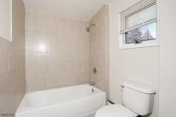 a white bath tub sitting next to a white toilet
