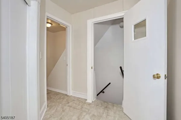 a view of a hallway with closet and a door
