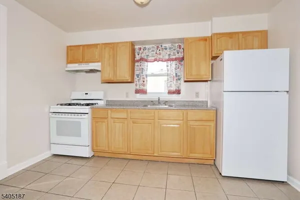 a kitchen with a white cabinets and white appliances
