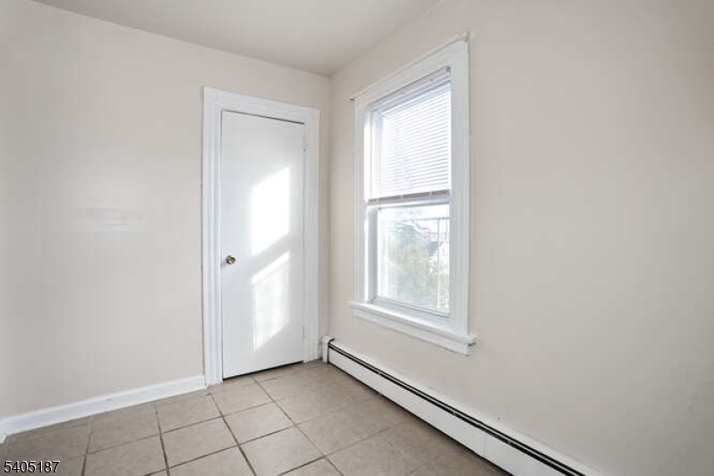 68 Mohawk Avenue Hawthorne, NJ 07506 - Photo 9 of 24 a view of an empty room and window