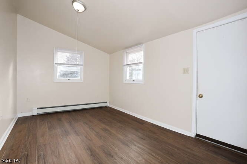 68 Mohawk Avenue Hawthorne, NJ 07506 - Photo 10 of 24 an empty room with wooden floor and windows